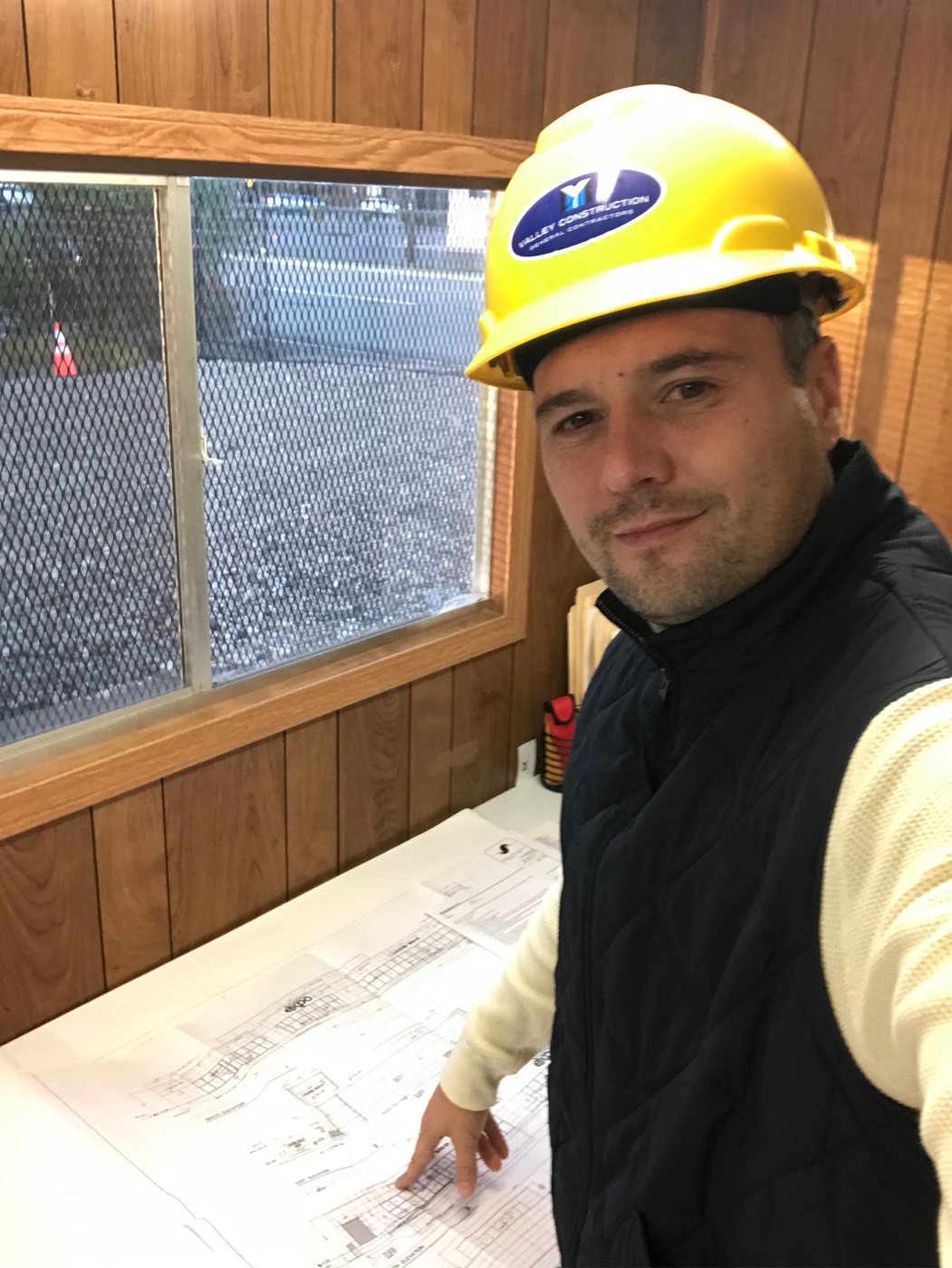 Valley Construction principal reviewing project drawings on site